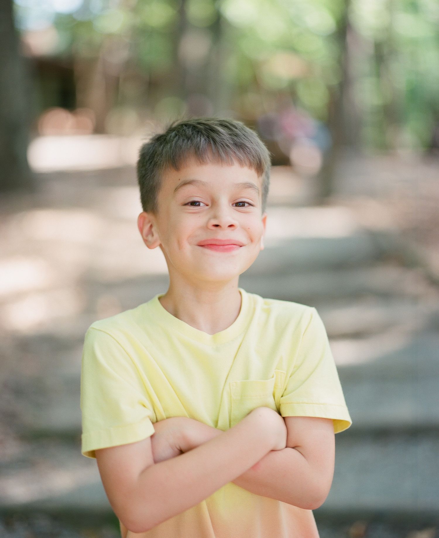 A sequence showing playful expressions in bright yellow attire against a blurred natural background.