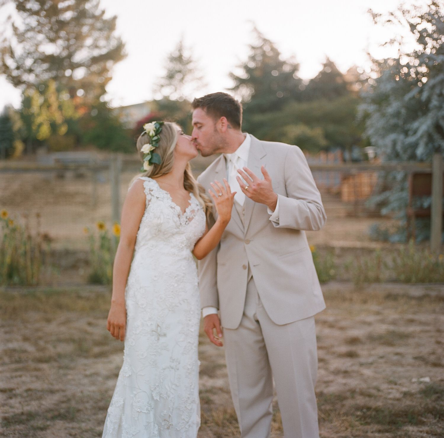 Bride and groom sharing a candid moment outdoors during their wedding photoshoot.