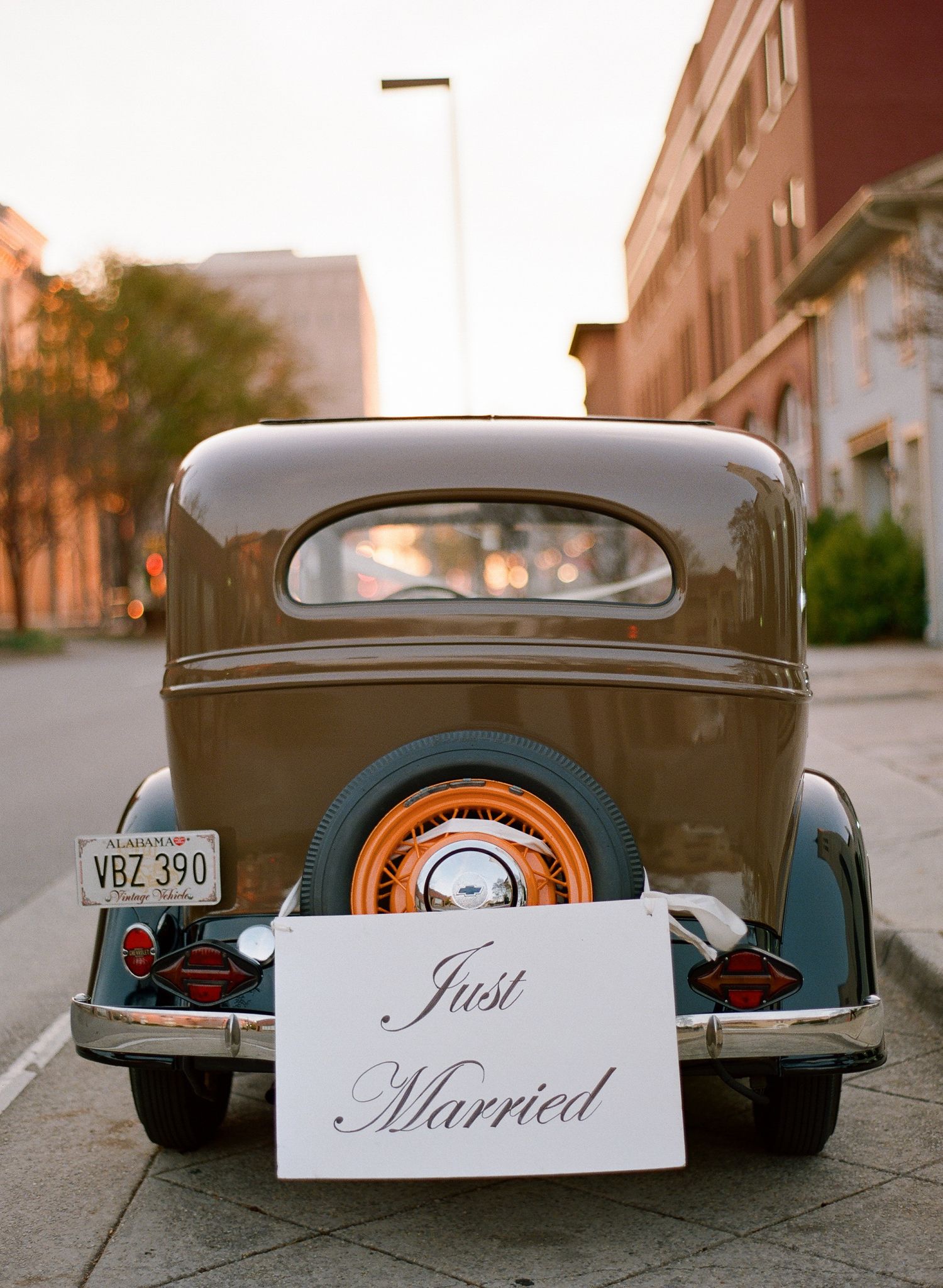 Classic vintage car decorated with 'Just Married' signs for a wedding celebration.