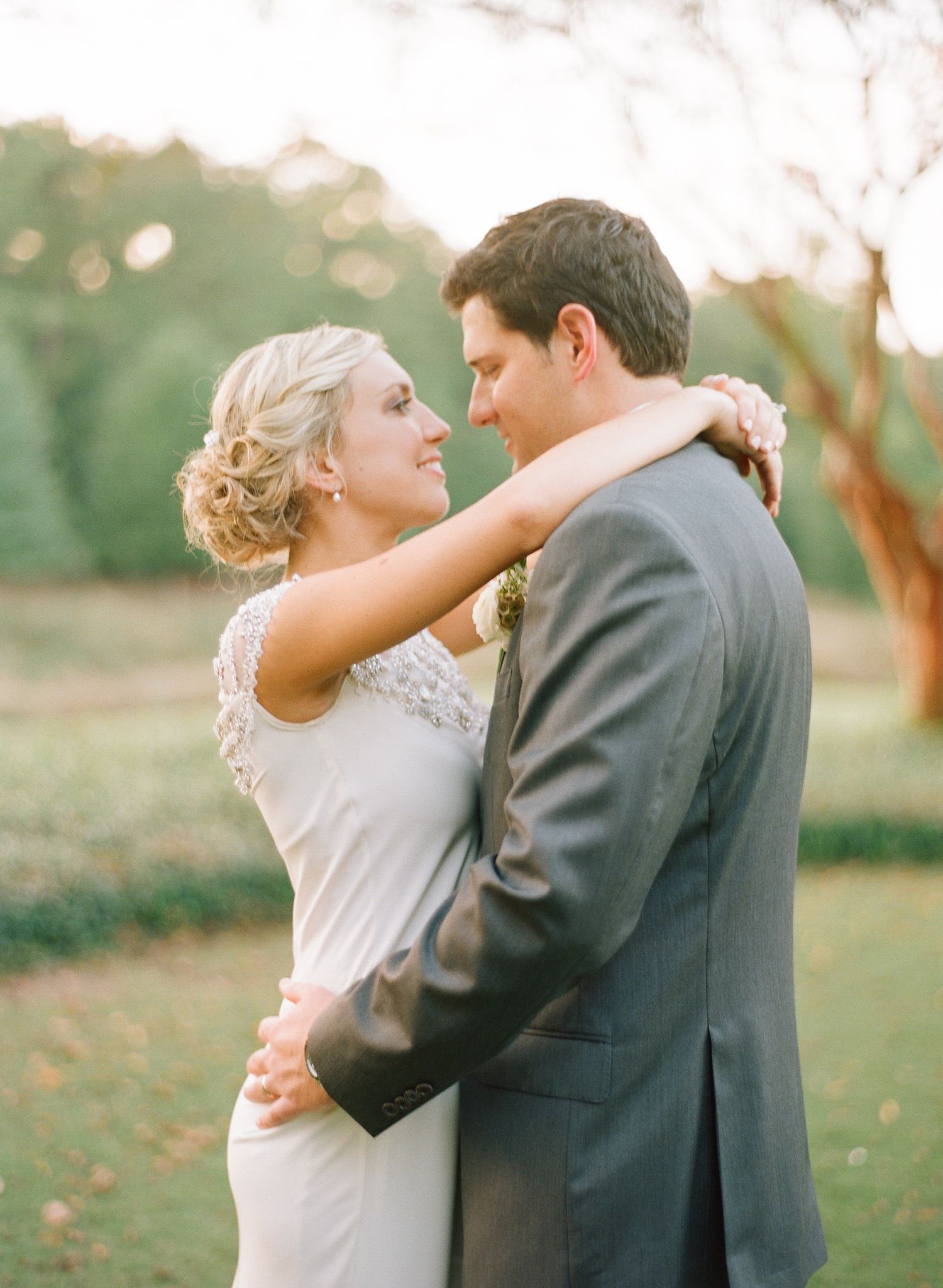 Newlyweds share romantic dance moves during outdoor wedding celebration.