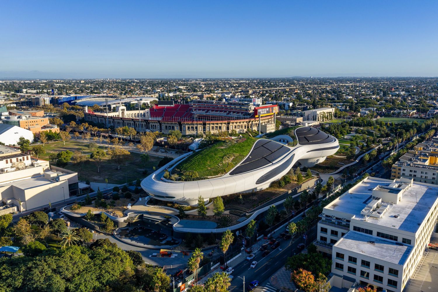 Panoramic cityscape showing modern stadium architecture integrated into urban surroundings.