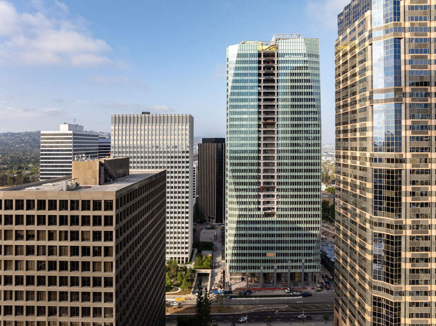 Downtown office buildings and skyscrapers photographed from high angle against blue sky.