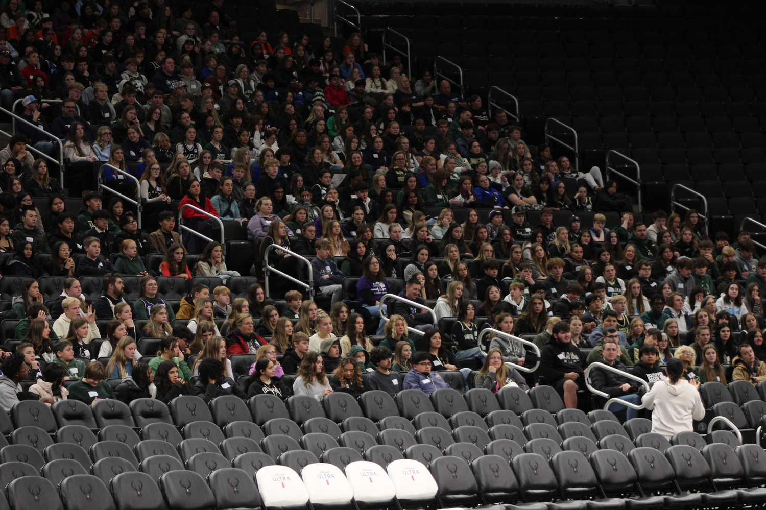 Large crowd of spectators filling arena seats during an indoor event or performance.