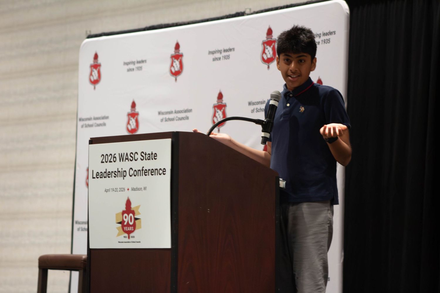 A young student speaks at the 2026 WASC State Leadership Conference podium.
