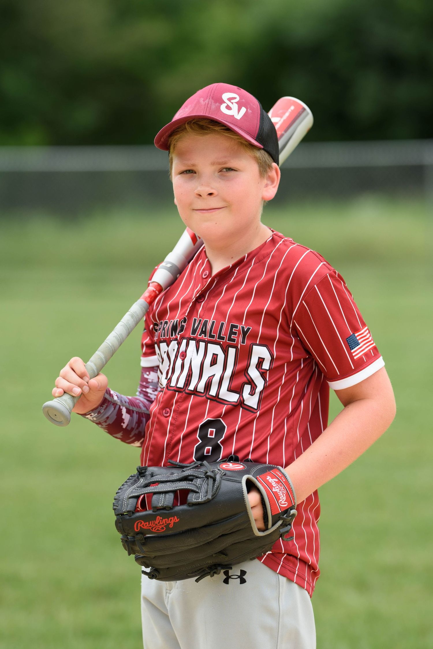 Youth baseball player number 8 in Spring Valley Cardinals uniform holding bat and glove for team photo.