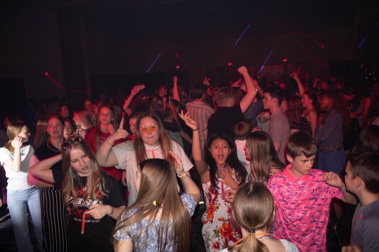 Students dance and celebrate together at a lively school leadership conference social event.