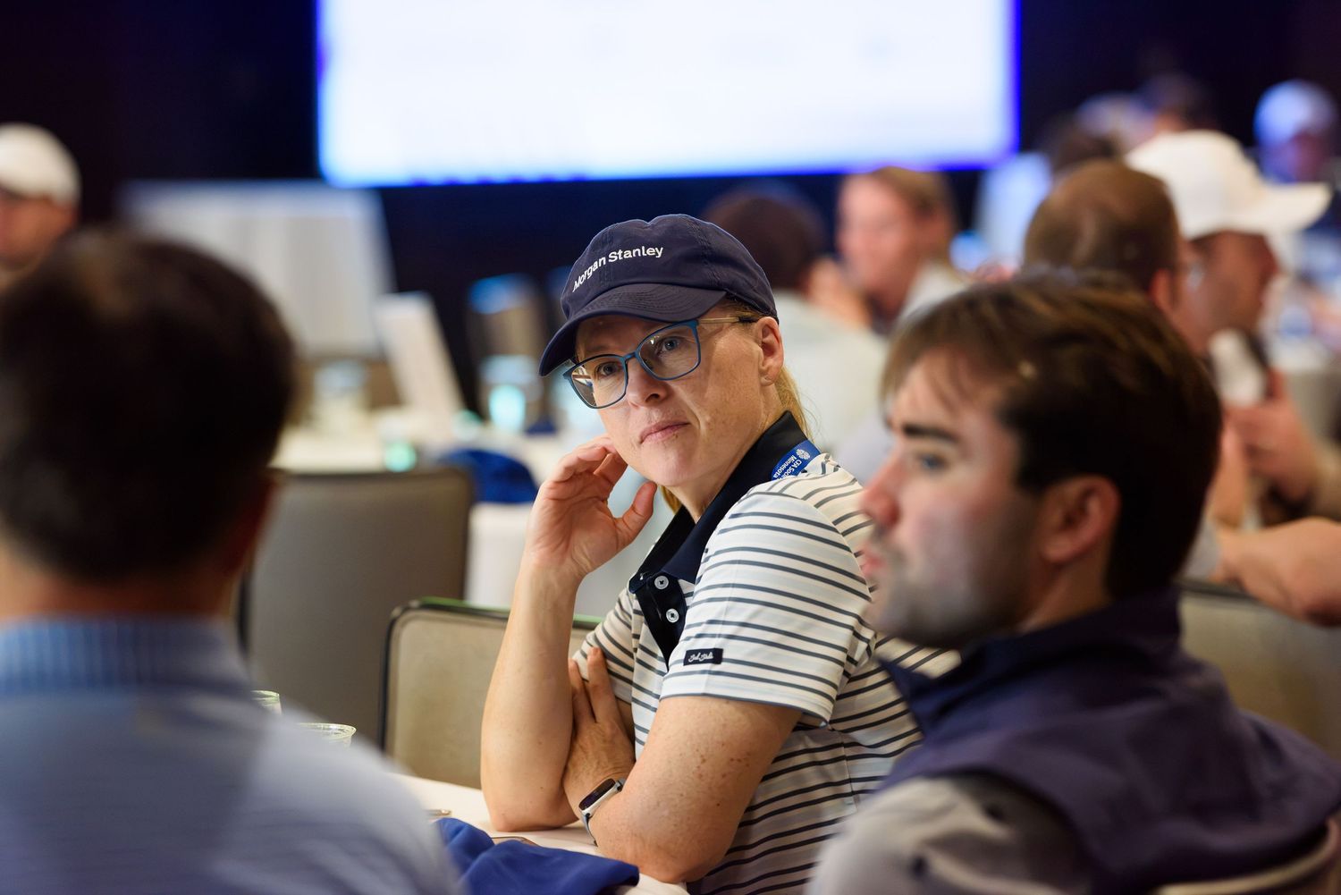 Attendees listening attentively at a professional conference event in a modern meeting room.