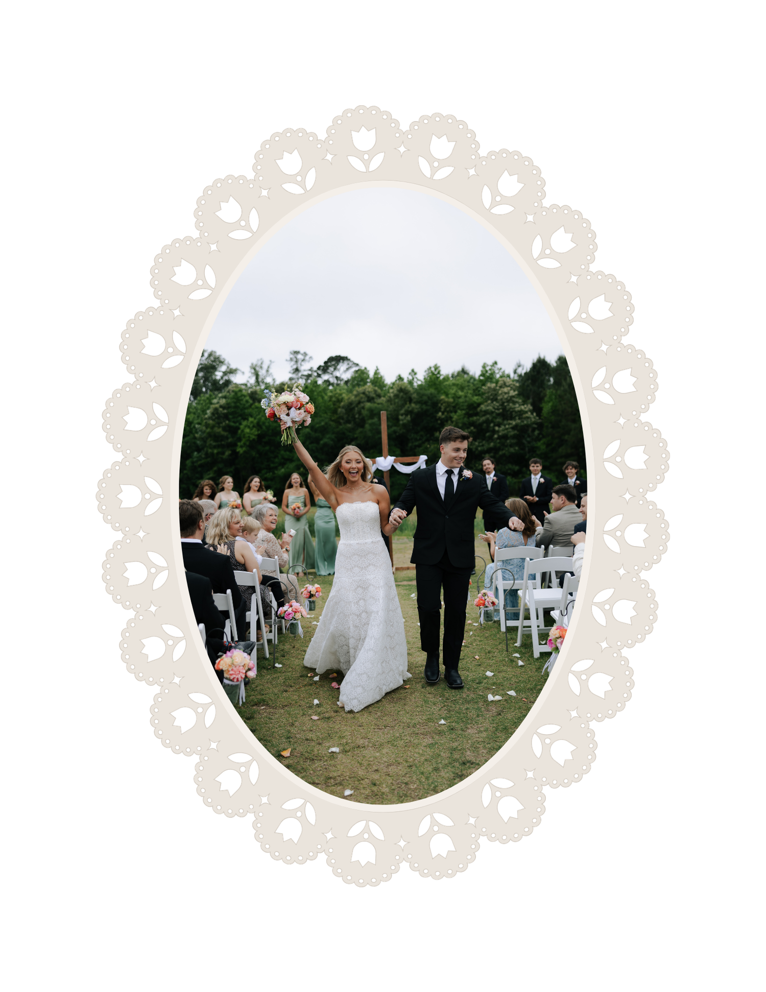 Newlywed couple celebrating at outdoor wedding ceremony, bride in white gown holding bouquet, guests seated on white chairs.