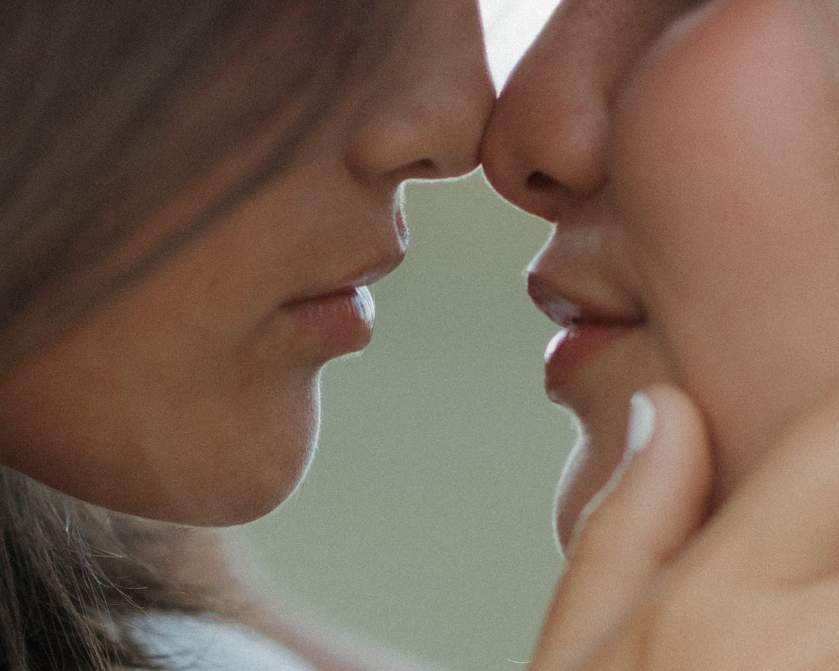 Close-up artistic sequence of two people about to kiss in soft lighting.