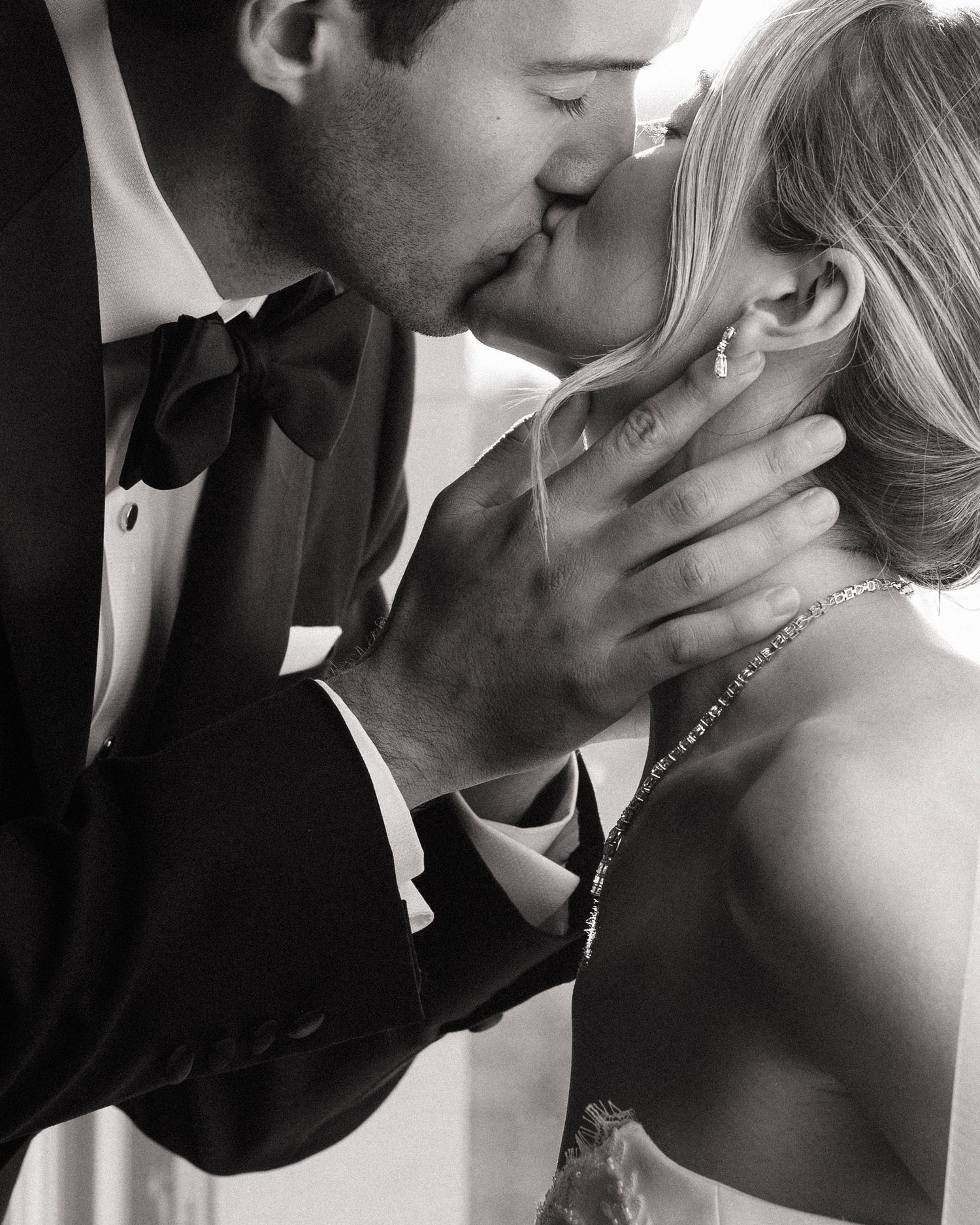 Close-up black and white photos capturing intimate romantic moments between newlyweds.