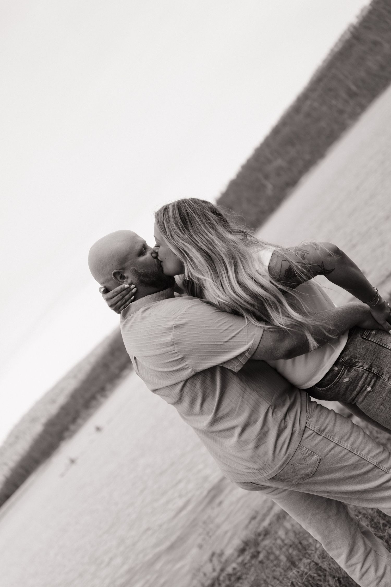 Black and white series of romantic poses by the water.
