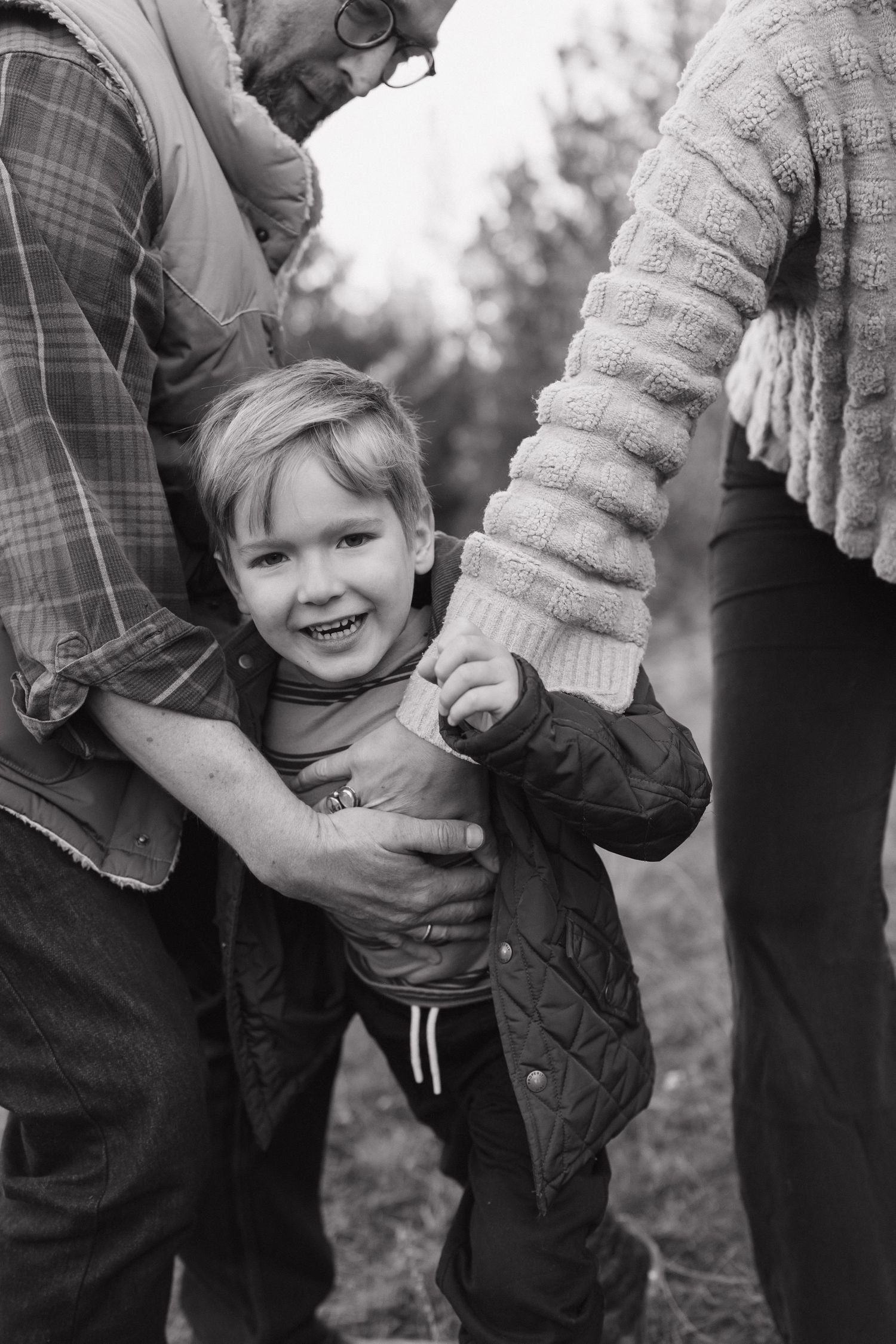 Black and white candid moment of playful interaction outdoors.
