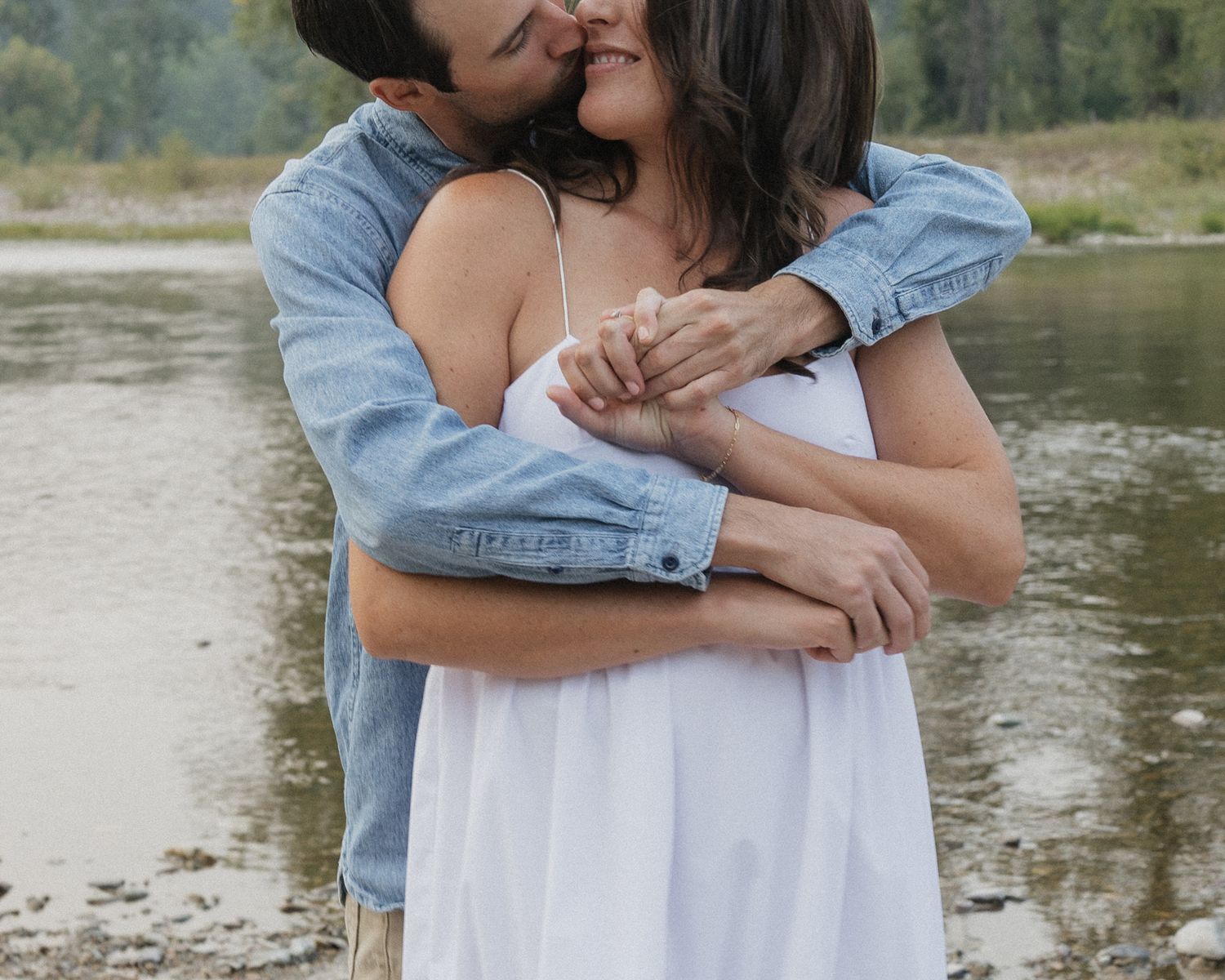 A tender embrace captured by the water's edge.