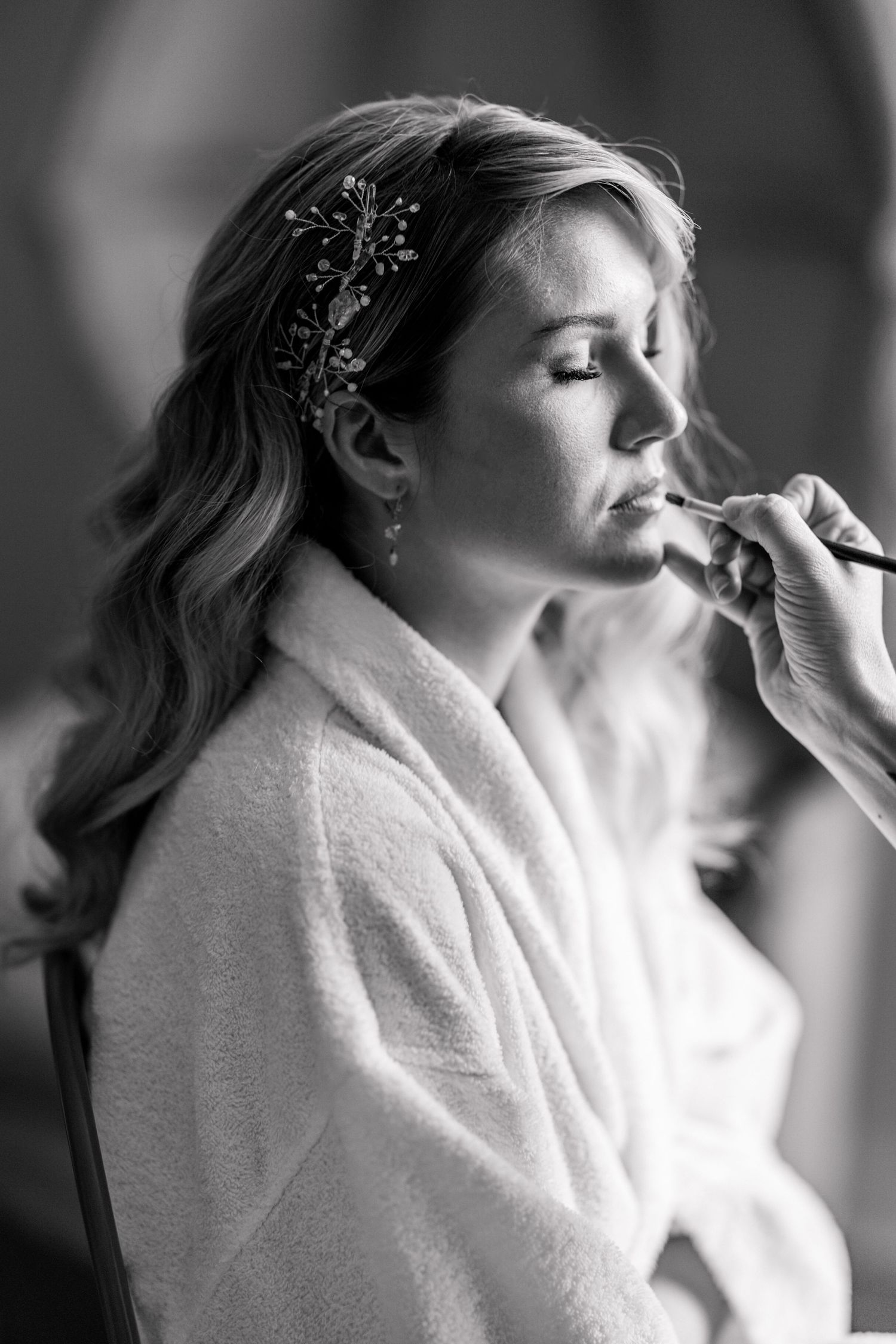 Black and white sequence showing preparation moments with makeup application.