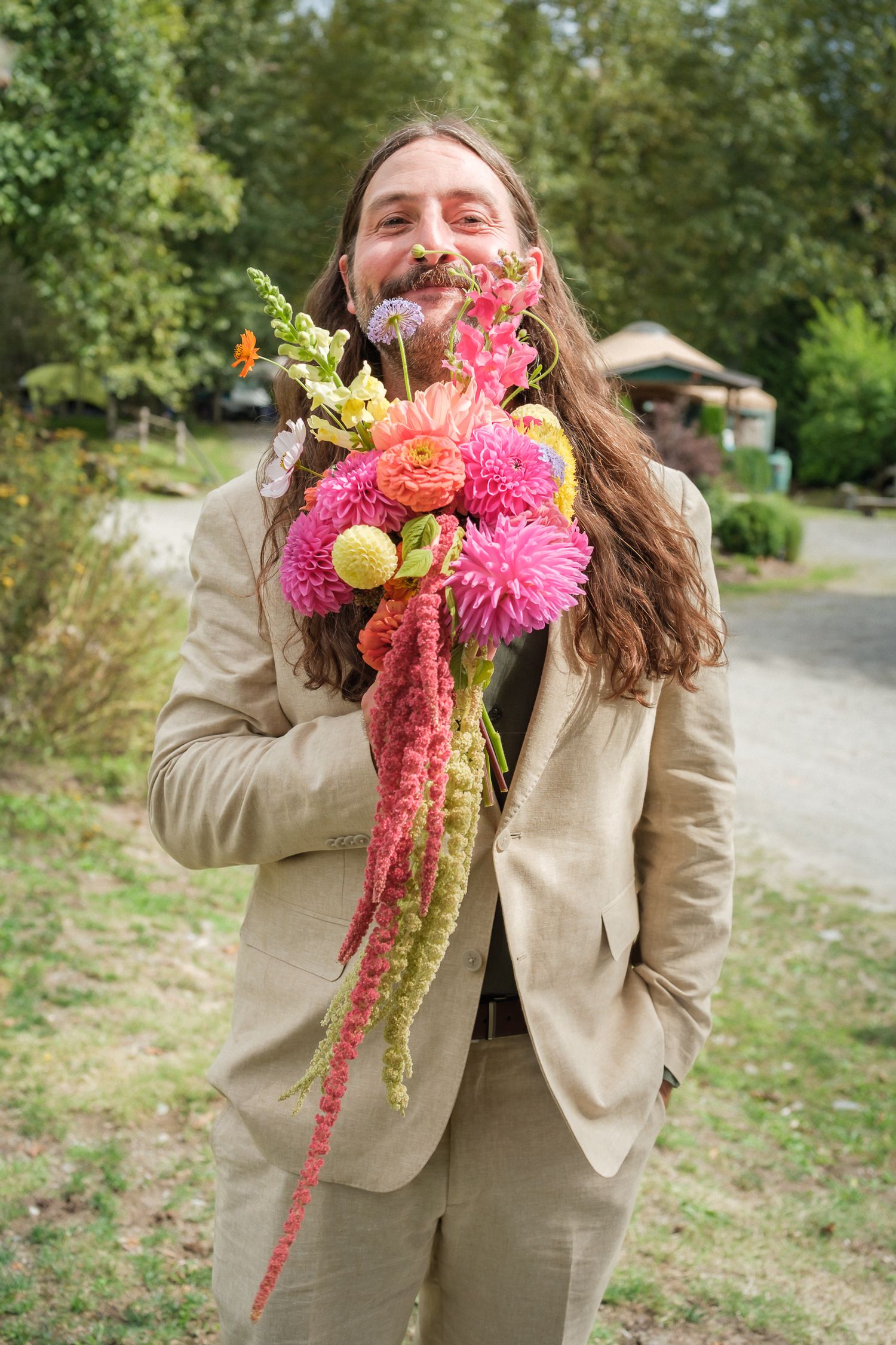 Candid groom with flowers