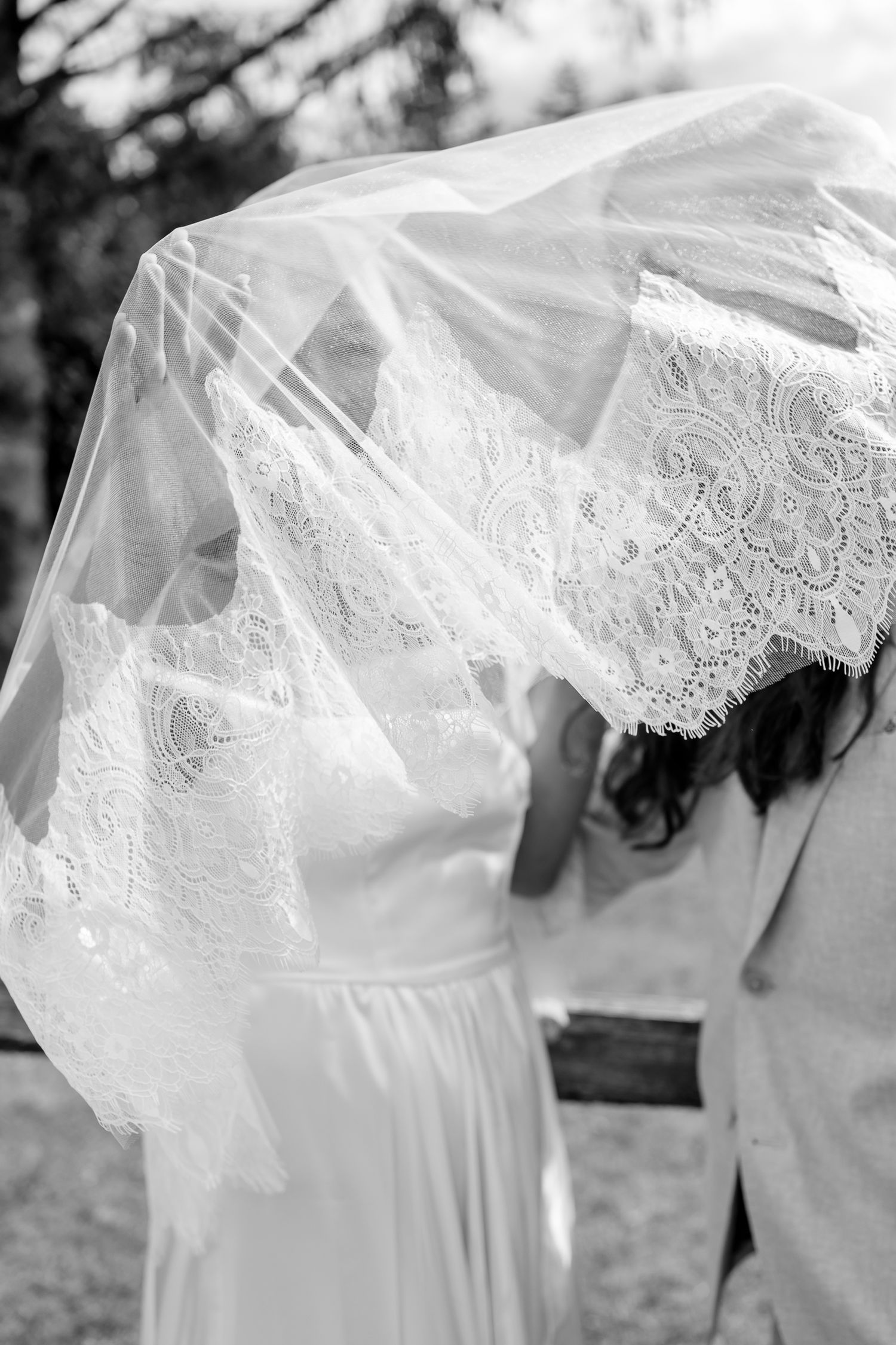 Intimate elopement first look with bride wearing detailed lace veil