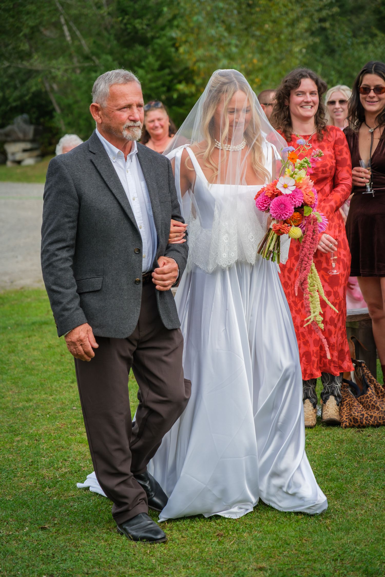 Candid bride walk outdoors with father
