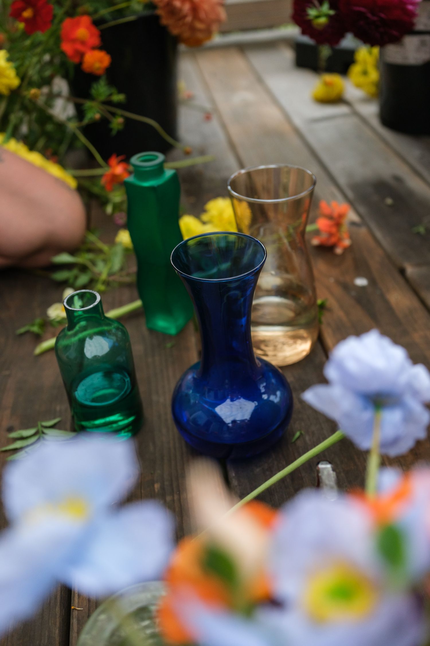 Colorful glass vase floral arrangements for rustic outdoor wedding reception