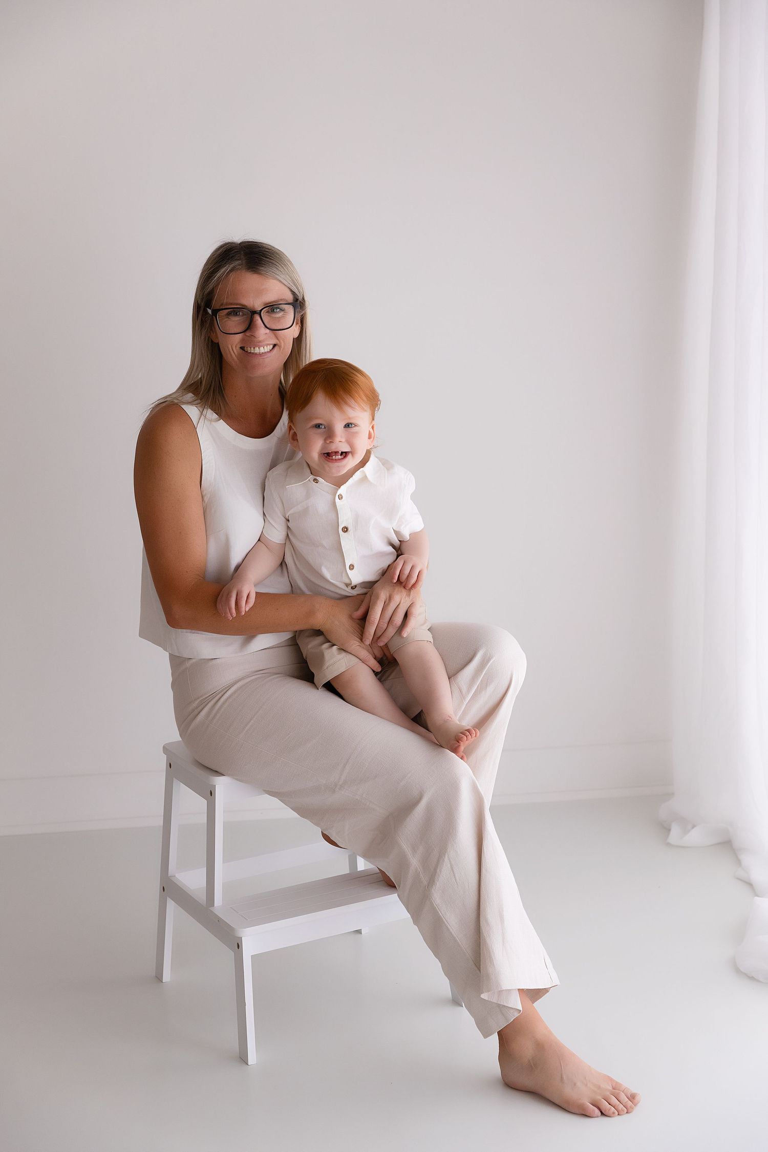 Grandmother with grandchild during a light and bright studio family photography session in Singleton NSW