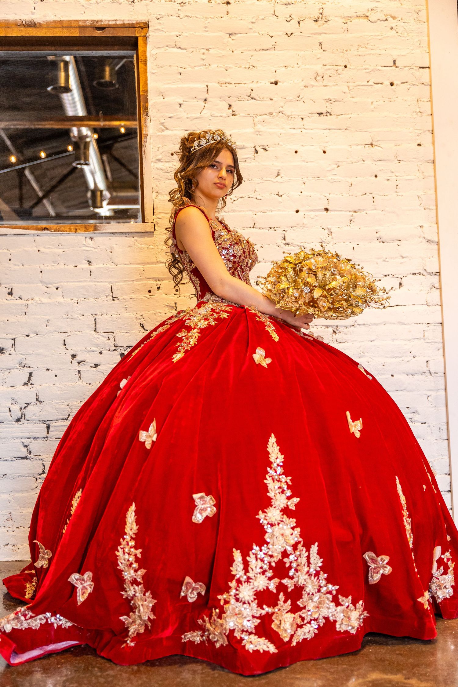 Quinceañera Portrait featuring red dress against a white wall