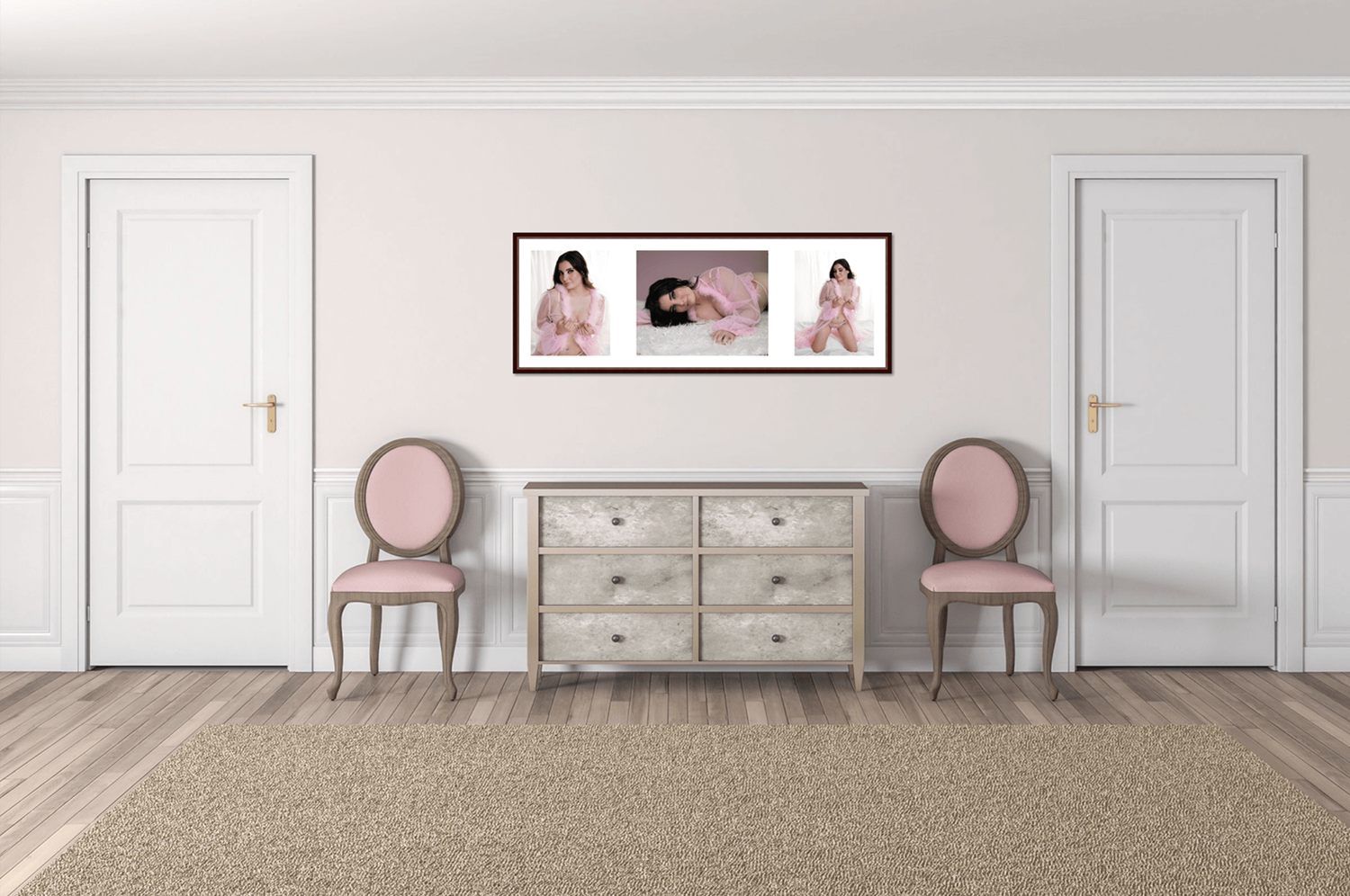 Elegant room display of framed newborn photography triptych above vintage dresser with pink accent chairs.