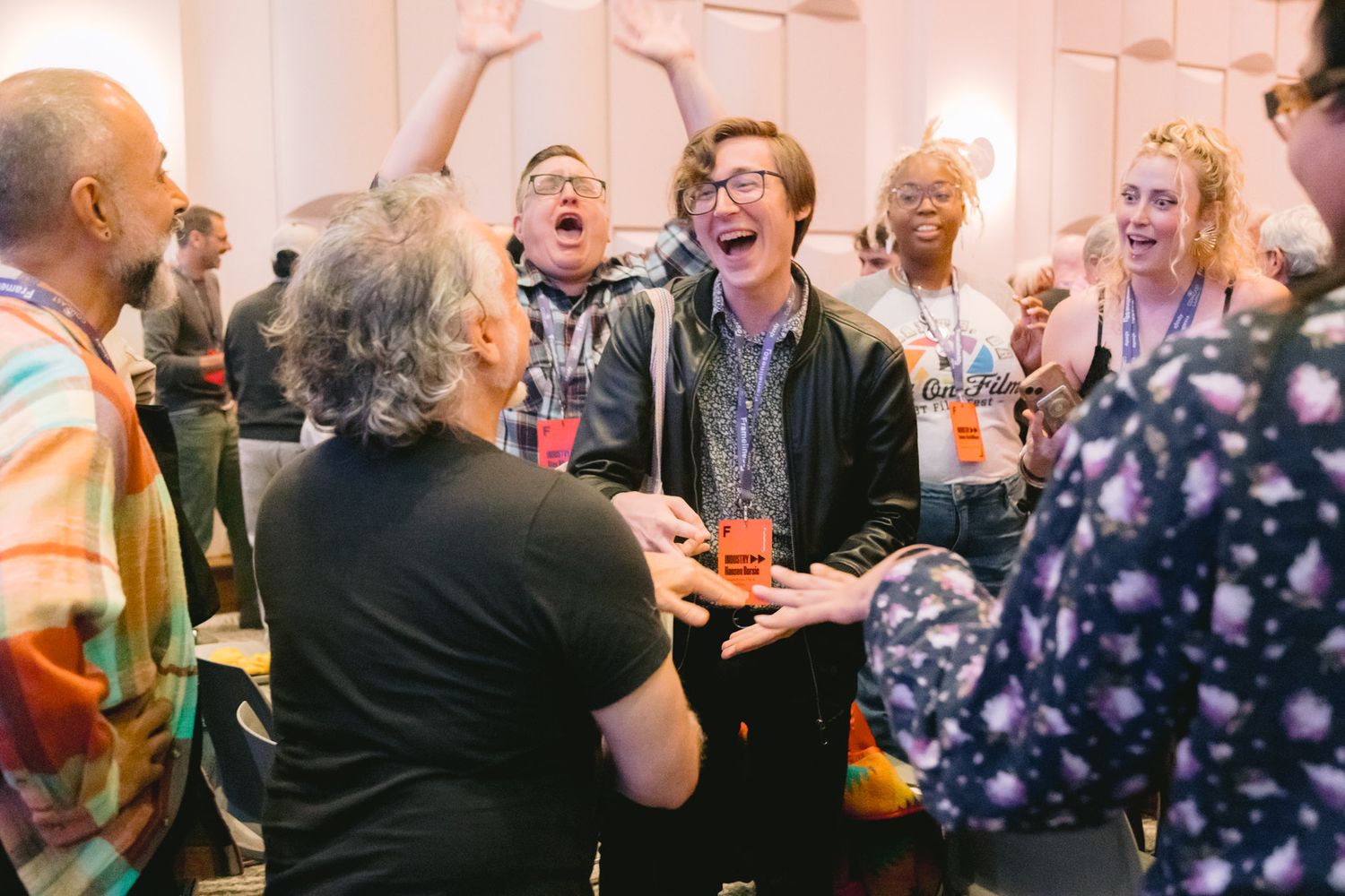 Diverse group of people laughing and celebrating together at Frameline50 LGBTQ film festival gathering.