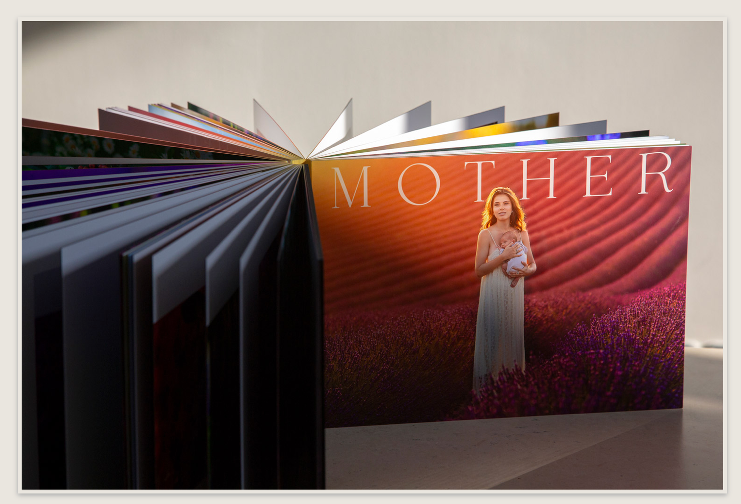 Hardcover MOTHER photo book standing open displaying colorful lavender field cover image.