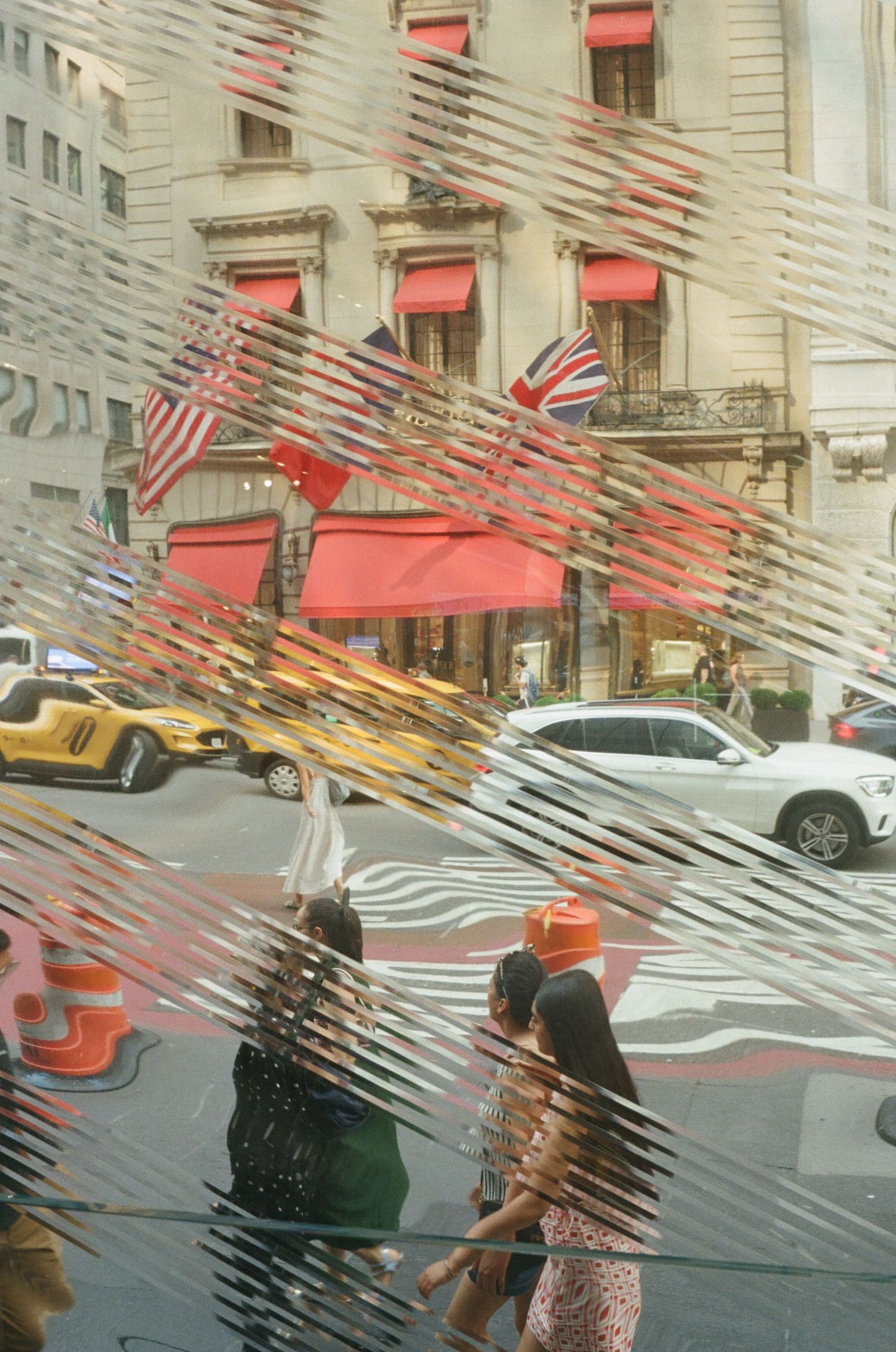 Street view seen through a textured glass window with reflections.