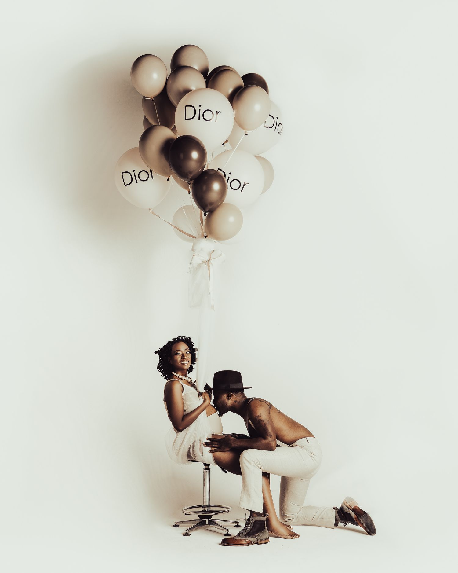 Creative family portrait combining an overhead newborn scene with a mother and child.