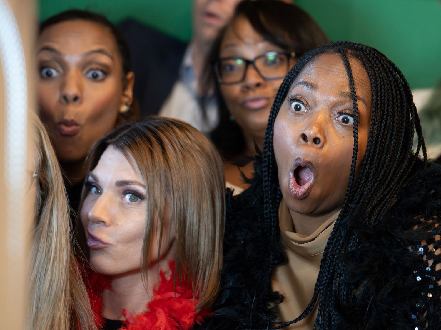 Group of event guests sharing a playful candid moment.