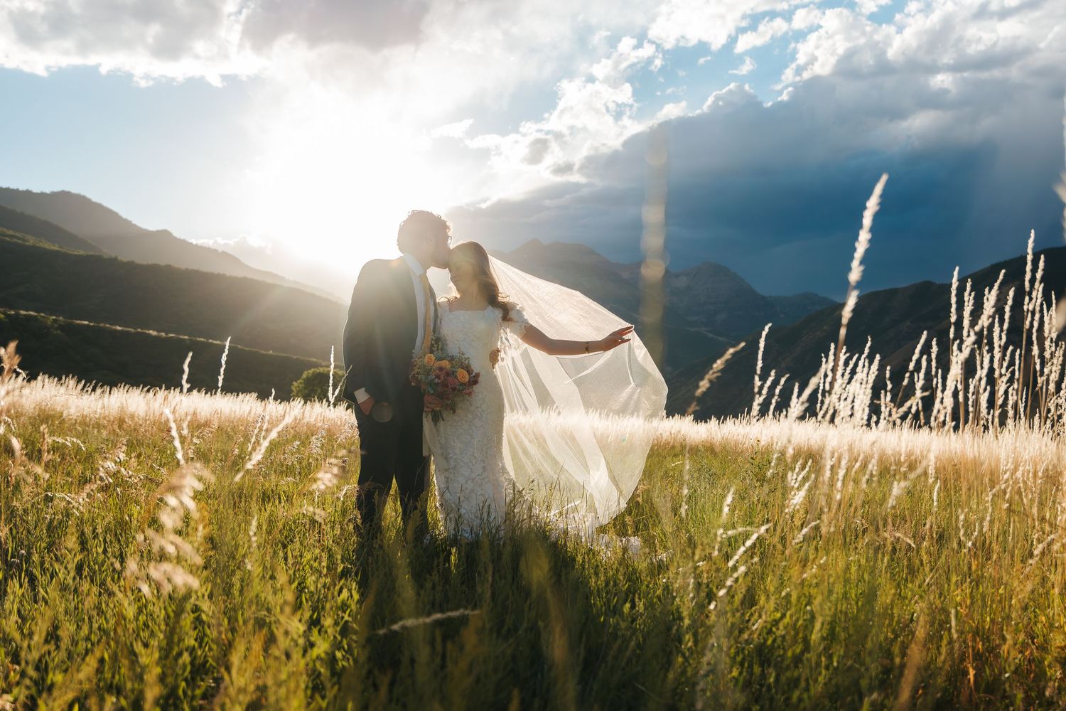 alberta and BC wedding and elopement photography. Bride and groom pose in a field during golden hour. Destination wedding photographer