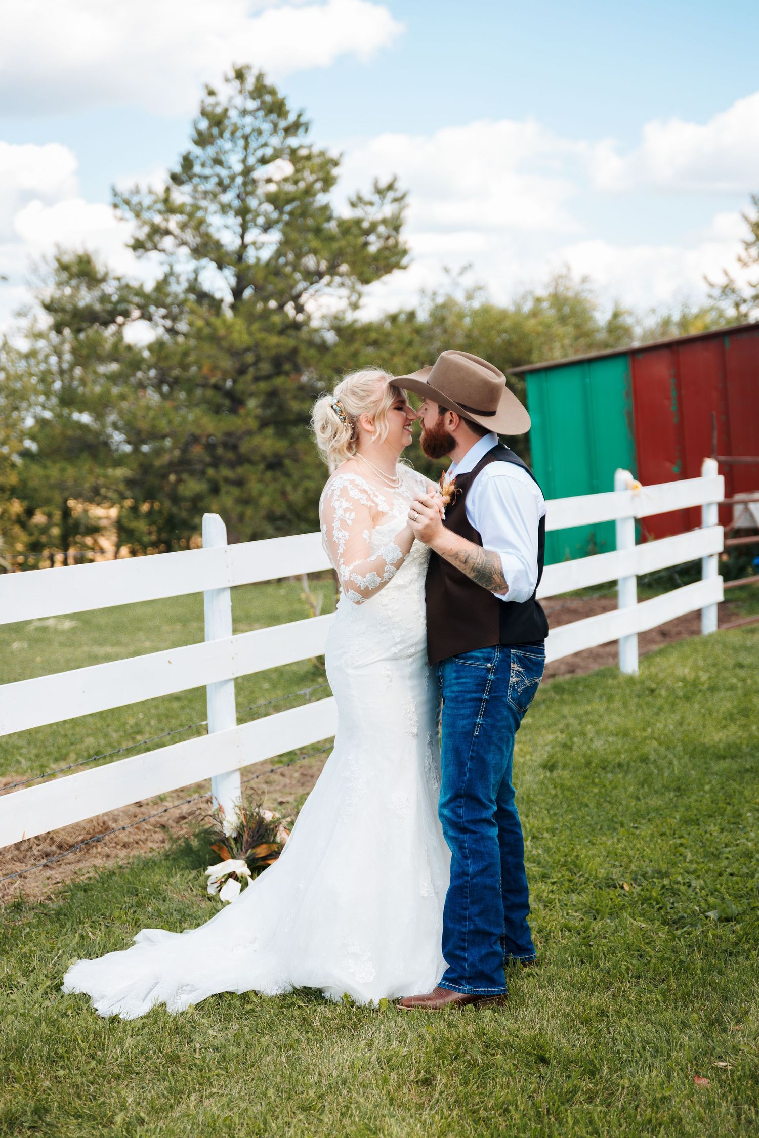 Athabasca wedding photographer. Western wedding at a barn. Bride and groom dancing in a field. Calgary candid wedding photographers