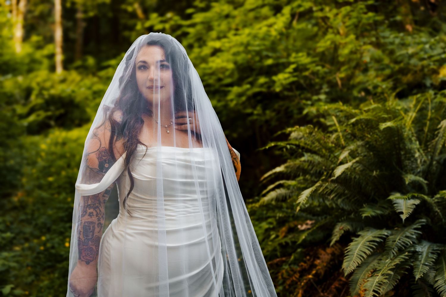 bride with veil standing in front of wall of ferns on vancouver island, cowichan wedding venues, banff elopement photography,