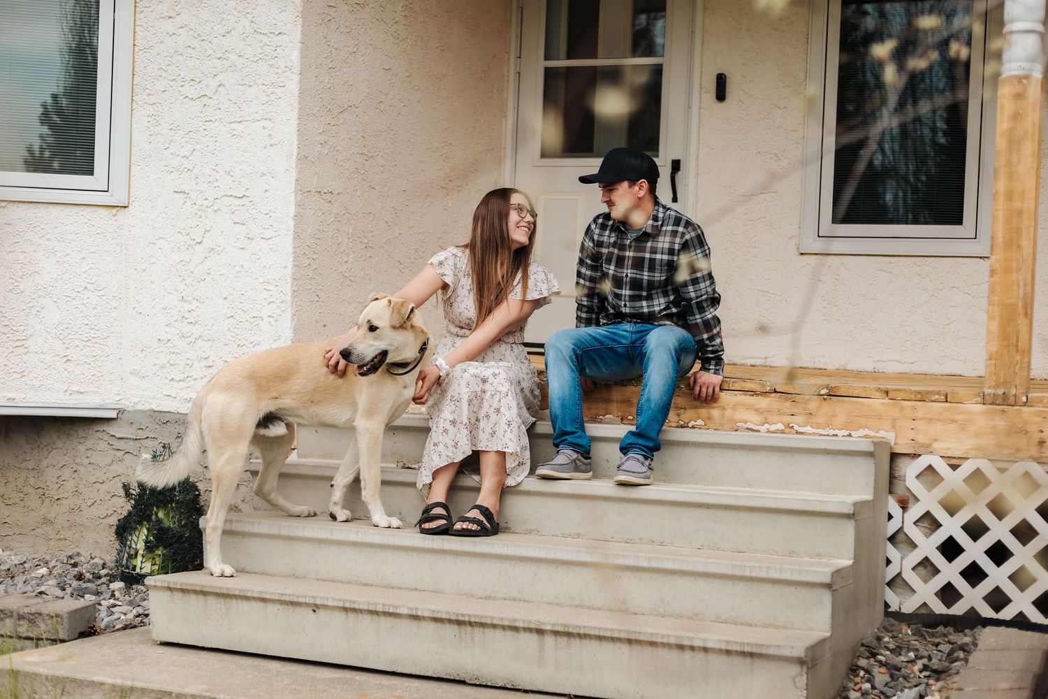 engagement photoshoot. couple sits on porch with dog. wedding photography. destination wedding in mexico. Alberta wedding venues