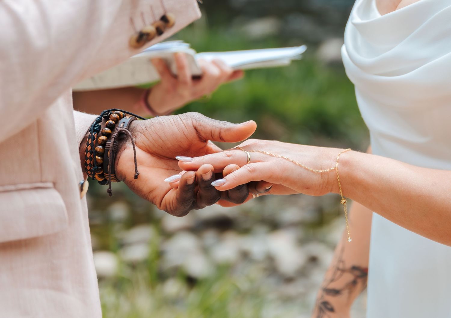 edmonton wedding photographer. Mill creeek ravine. bride and groom exchange rings and vows during ceremony at an elopement. Wedding dresses