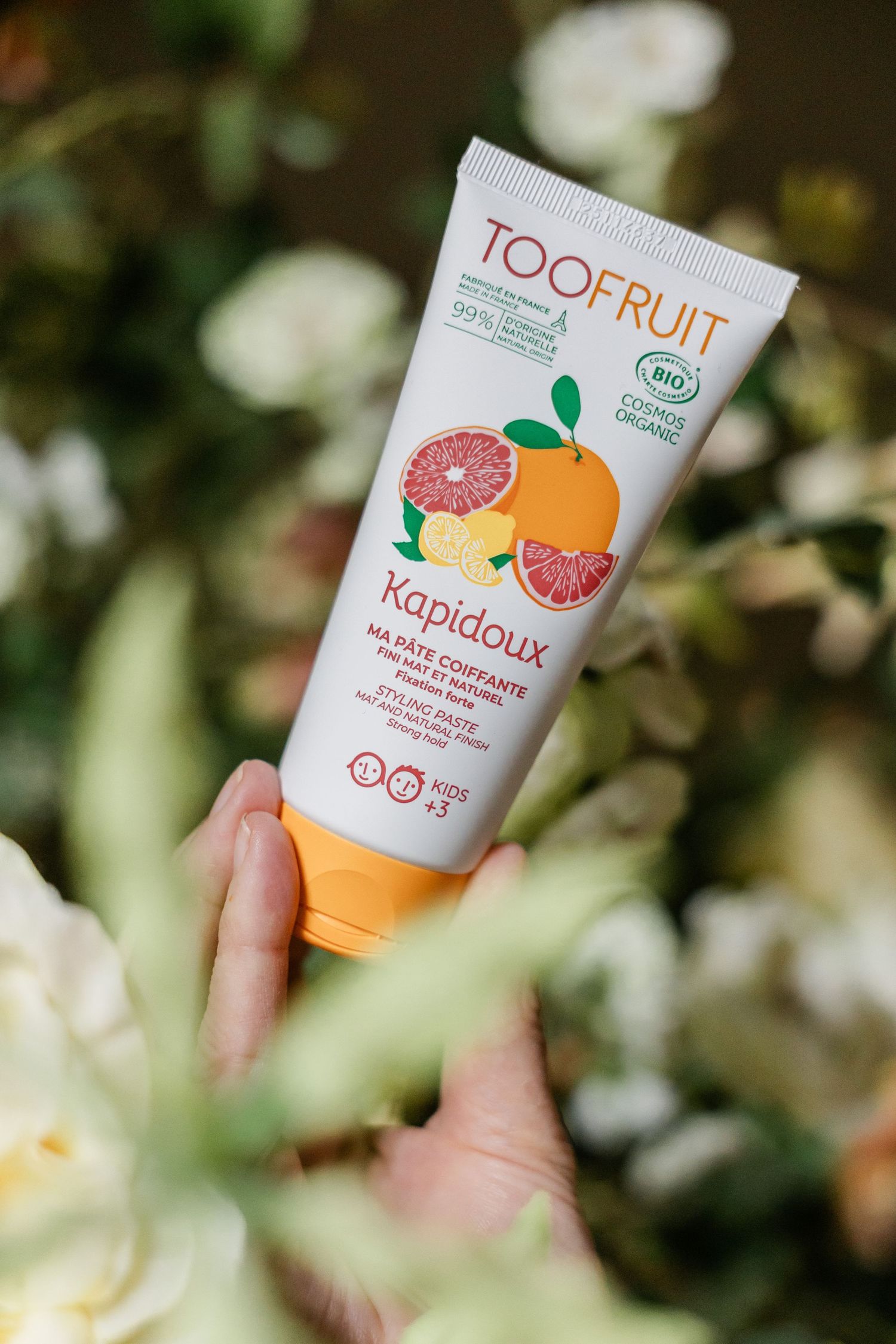 TOOFRUIT Kapidoux biologische haarstylingpasta voor kinderen in een tube met citrusthema.