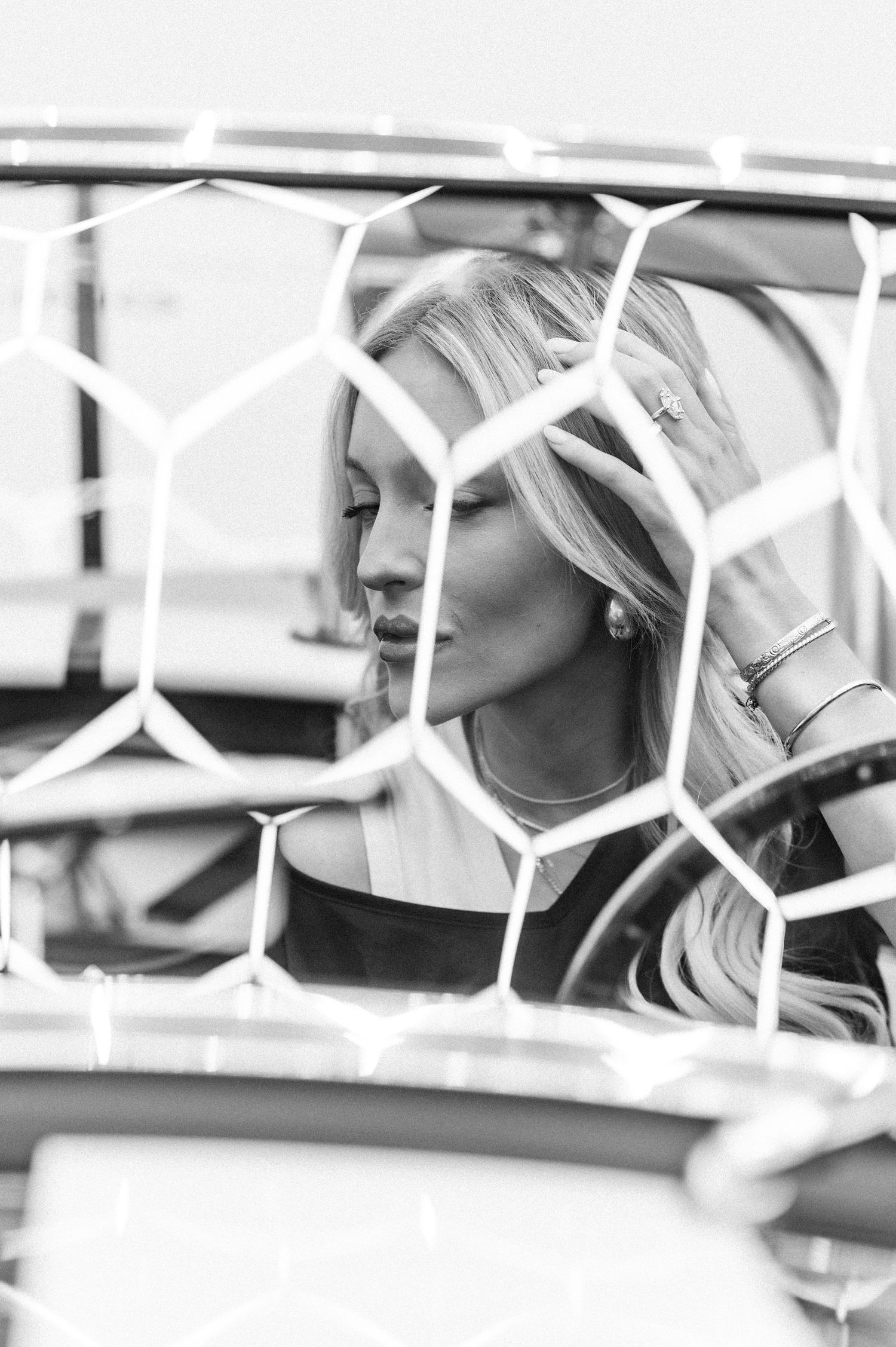 black and white photo using hexagon shape with a girl sitting in the drivers seat of a car