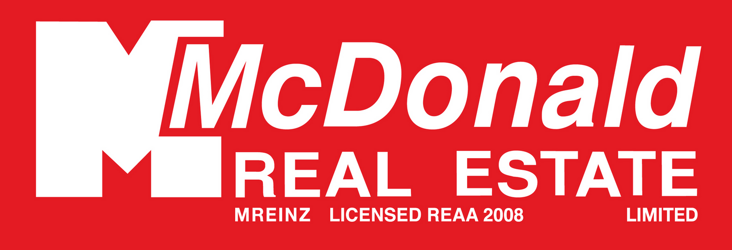 Red rectangular logo for McDonald Real Estate Limited showing business licensing details from 2008.