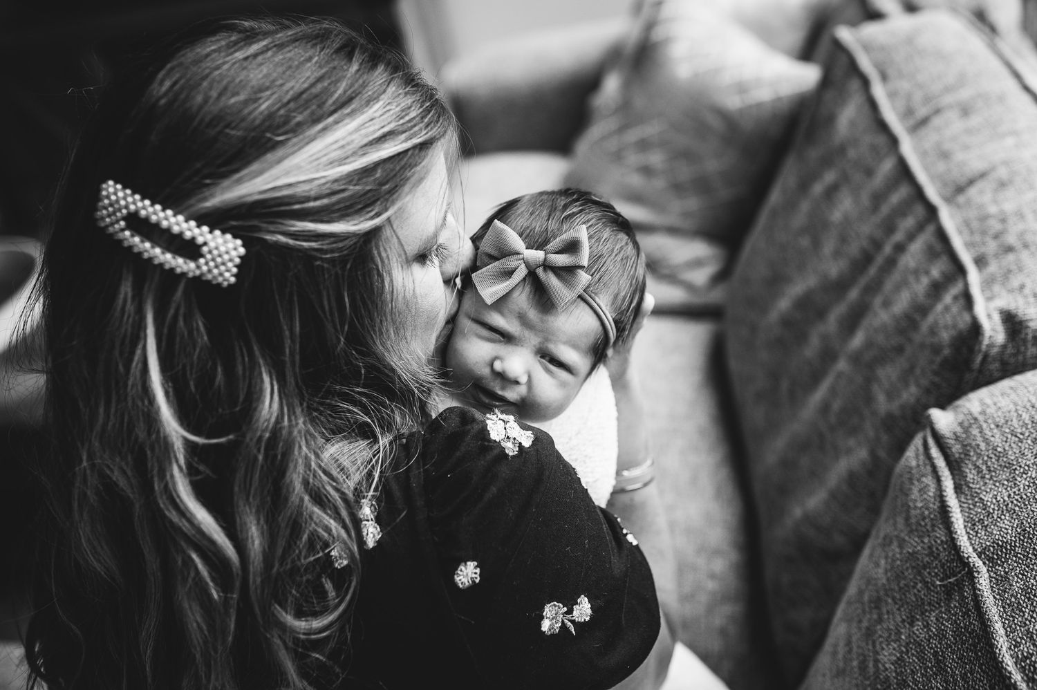 mom-kissing-newborn-infant