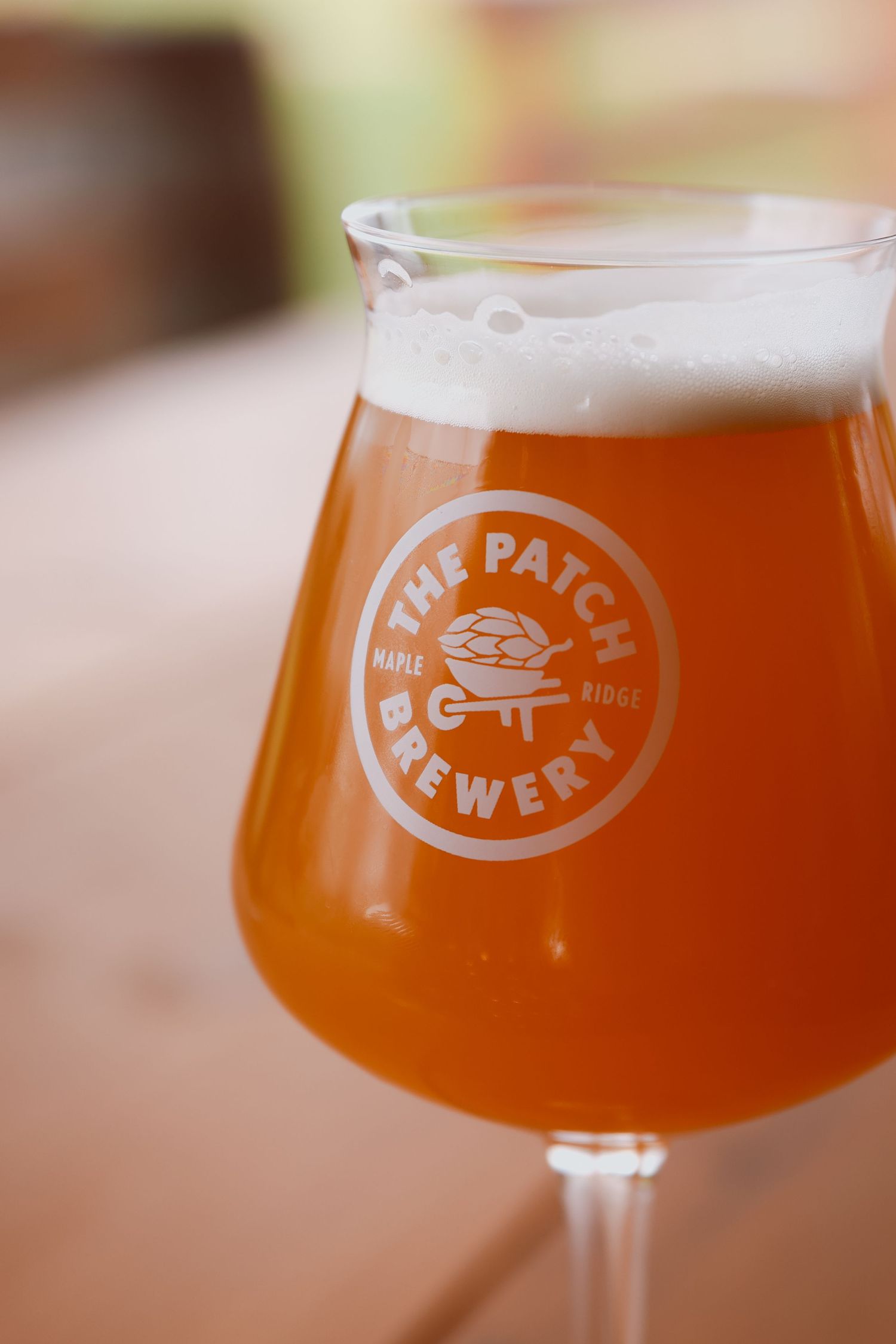 Glass of craft beer from The Pat Co. Brewery with foamy head.