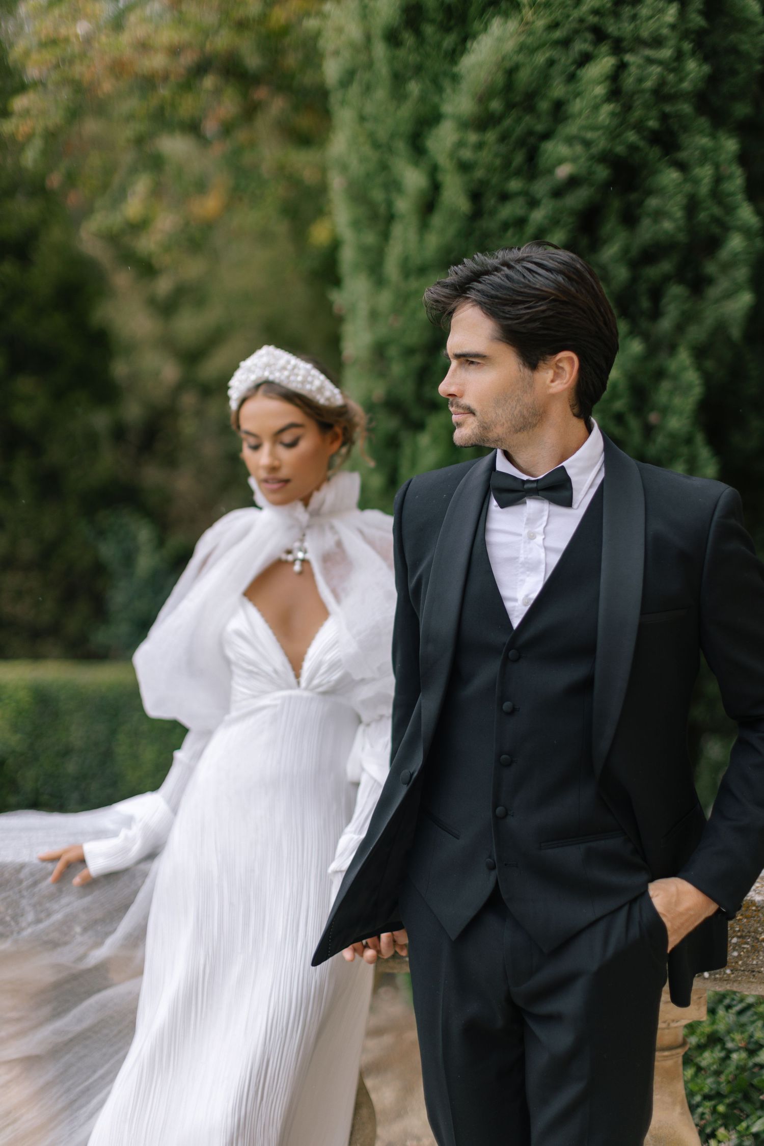 A romantic wedding photo series showing a couple in traditional white dress and black tuxedo posing outdoors.