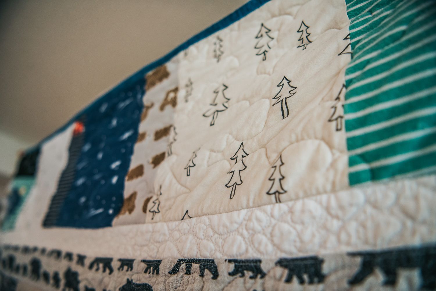 Patchwork sashing on a memory quilt showing fabric with trees and other nature themed fabrics.