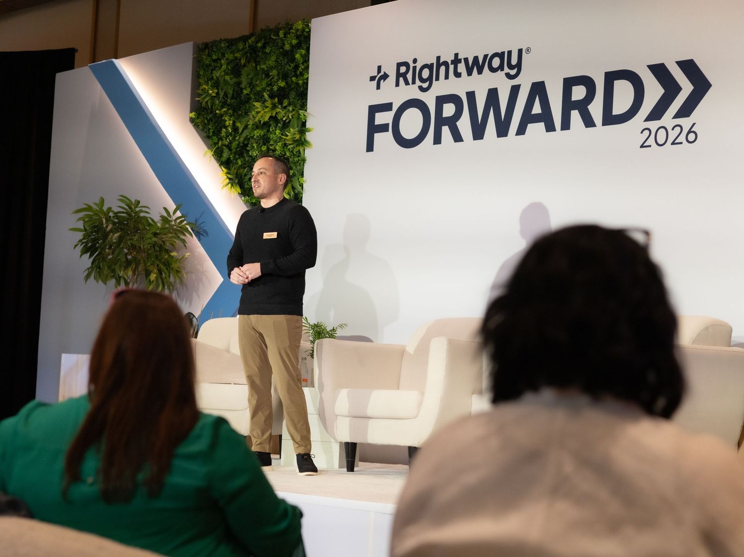 Speaker presents on stage at Rightway Forward 2026 conference event with audience seated in foreground.