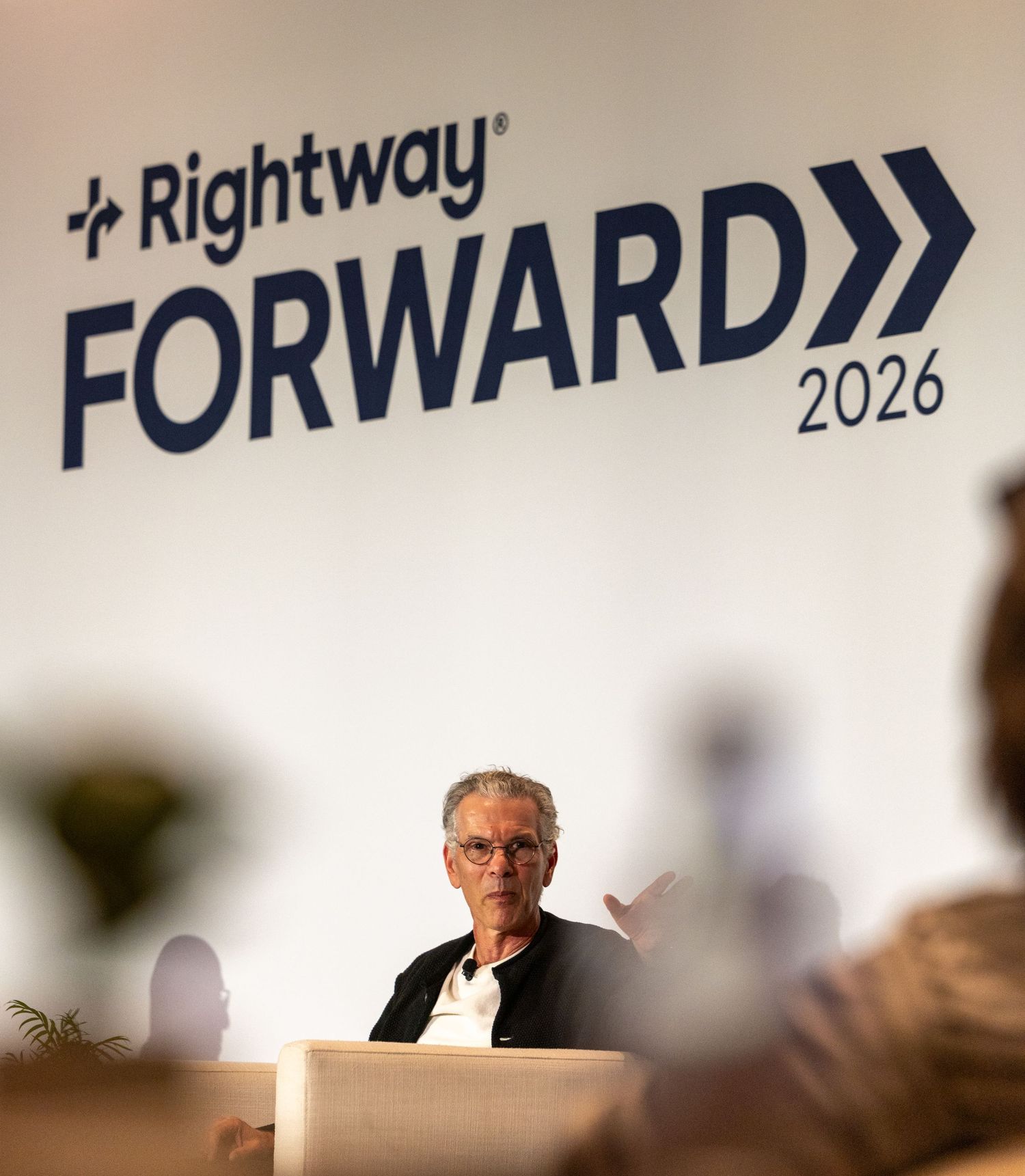 Person speaking at Rightway Forward 2026 event on a white stage backdrop.