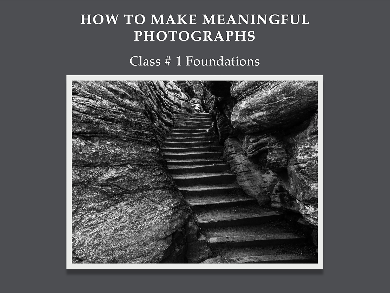 Black and white photo of stone stairs winding through rocky canyon walls, foundations of photography class.