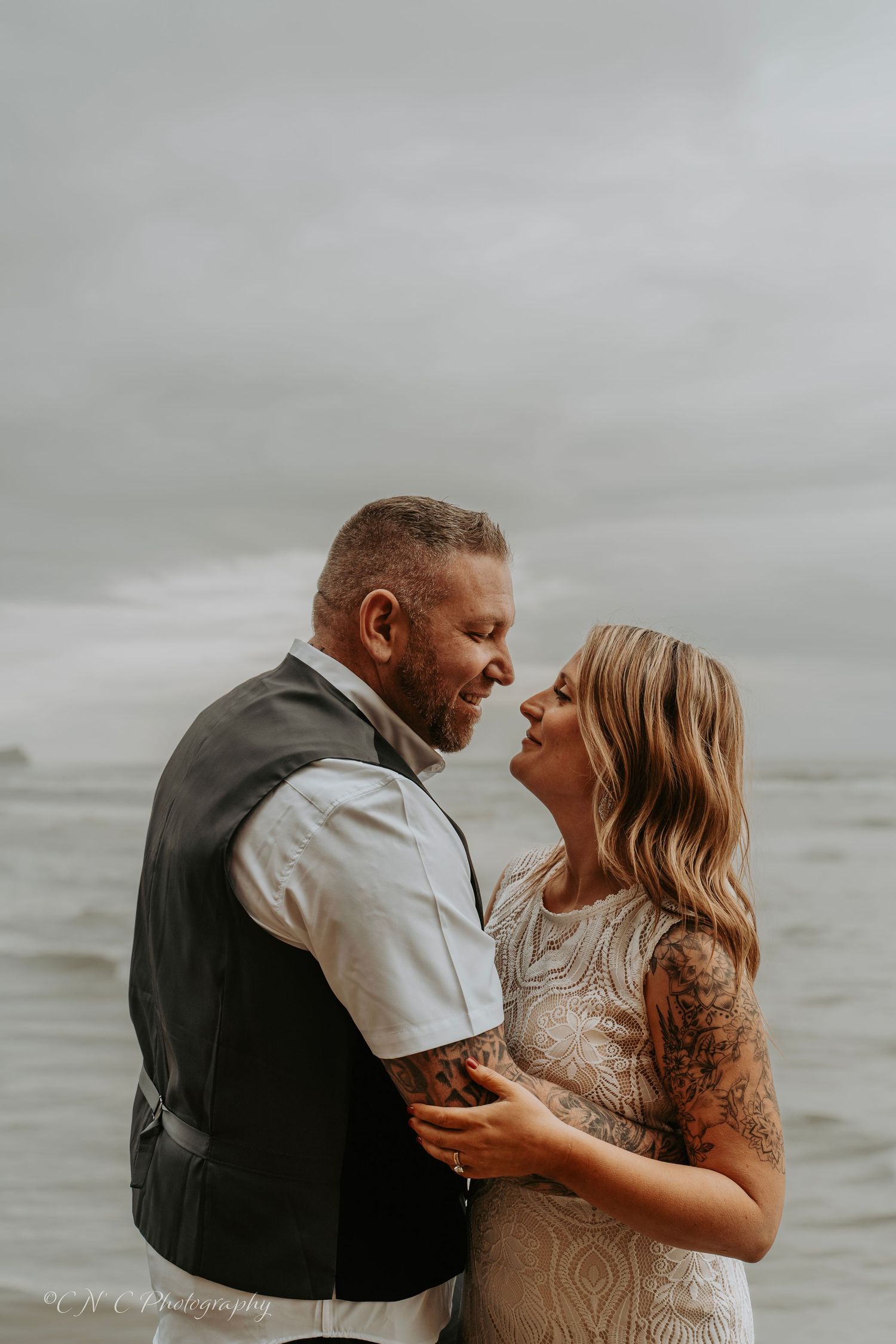 Moody beach portrait on overcast day with grey skies and ocean backdrop.