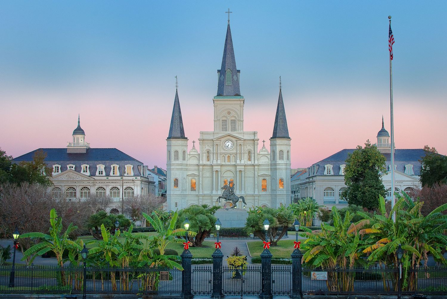 Saint Louis Cathedral glows at twilight in New Orleans historic Jackson Square.