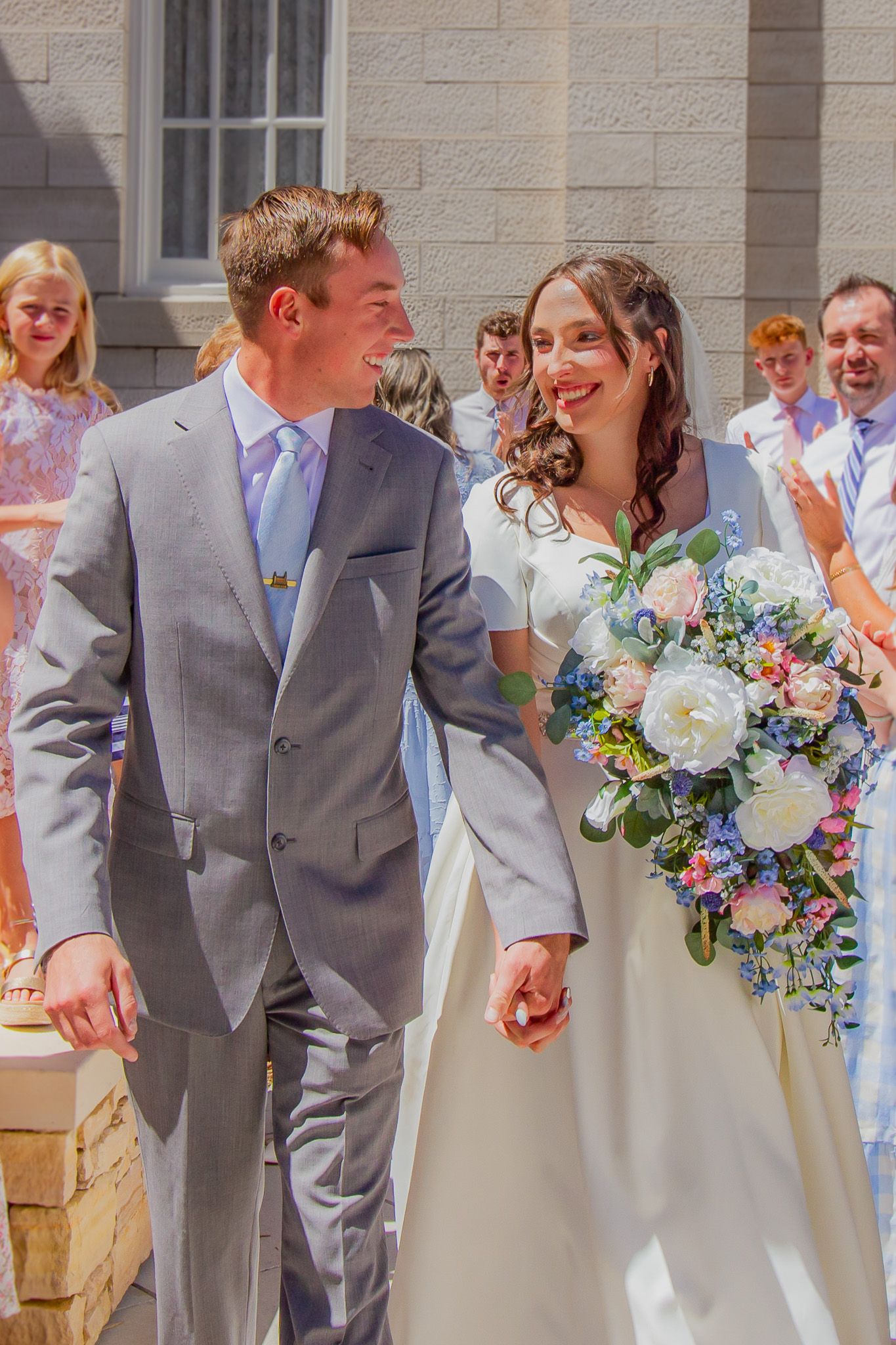 Bride and Groom smiling and looking at each other during Manti Utah Temple exit wedding