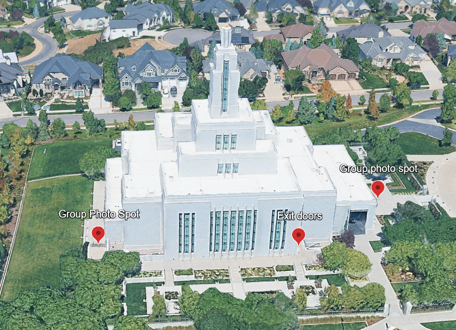 Aerial view of a white LDS Mormon temple surrounded by green lawns and suburban homes, with photo spot markers visible.