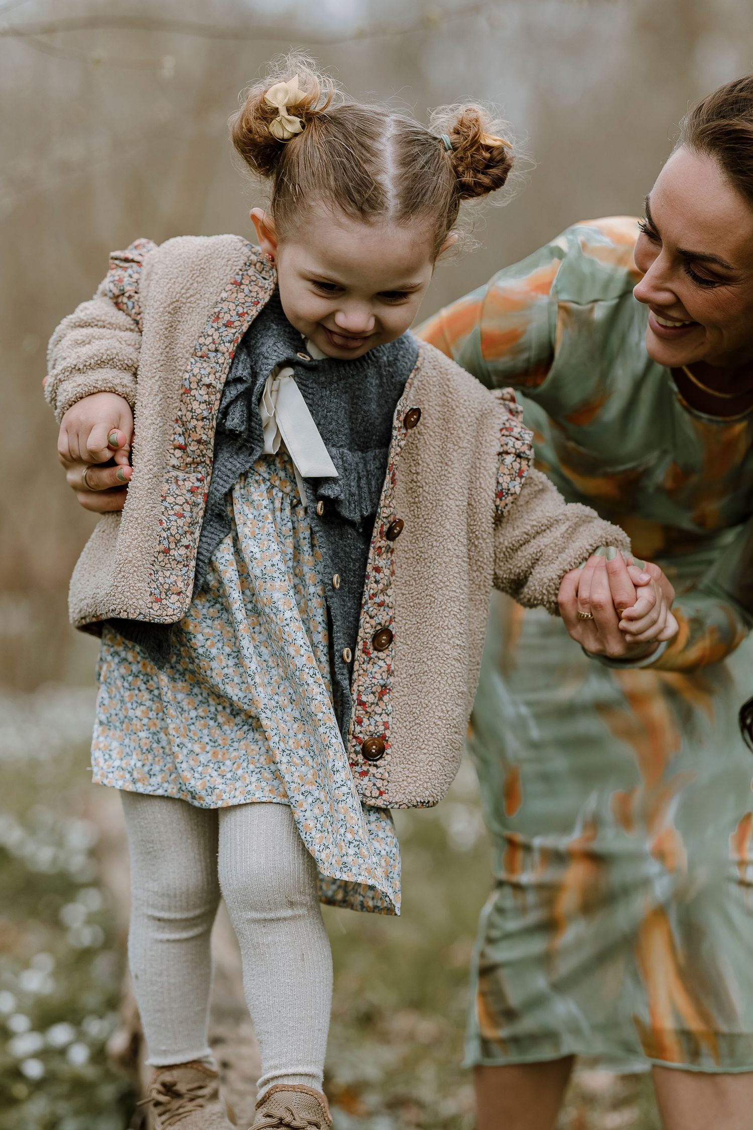 A series of candid shots showing a toddler in a beige cardigan and floral dress interacting with someone in an outdoor setting.